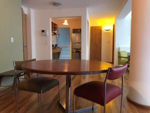 a dining room table and chairs in a room at Departamentos Pánuco in Mexico City