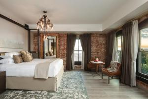 a bedroom with a large bed and a brick wall at The Charmant Hotel in La Crosse