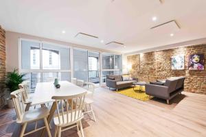 a living room with a table and chairs at Temple Bar Crown Square Apartments in Dublin