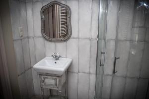 a bathroom with a sink and a mirror at Pokoje Nad Arkadami in Zamość +87 photos