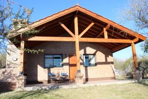 a pavilion with a wooden roof on a house at Casa Crisolito in Merlo