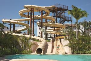 a large swimming pool with a bunch of surfboards in it at Dreams Playa Mujeres Golf & Spa Resort in Cancún