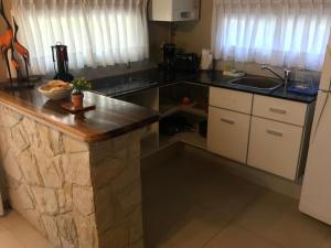 a kitchen with a counter top and a sink at Complejo Pampa in Mar de las Pampas