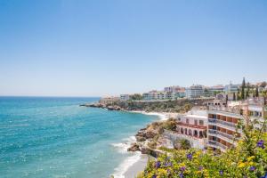 a view of a beach with buildings and the ocean at Canovas Nerja - Balcón de Europa in Nerja