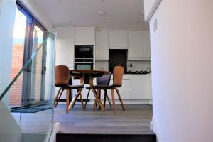 a kitchen with a table and chairs in a room at Cadmiae in Winchester