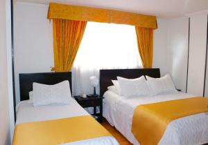 Postel nebo postele na pokoji v ubytování Hotel Ferrovial Corferias