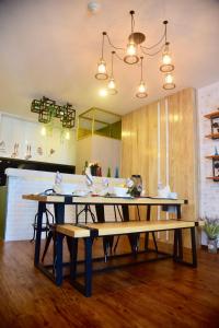 a kitchen with a table and benches in a room at My Resort Hua Hin E306 in Hua Hin