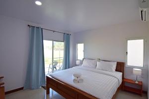 Un dormitorio con una cama con dos vasos. en Anissa Resort Koh Yao Yai en Ko Yao Yai