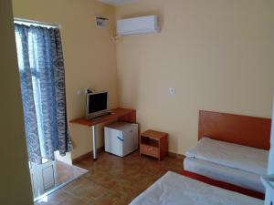a small room with a bed and a television at Hotel Toni in Bukovlŭk