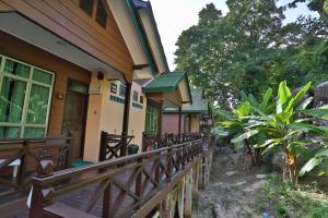a porch of a house with a wooden fence at Tuna Bay Island Resort in Perhentian Islands