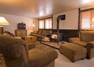 a living room with a fireplace and a couch and chairs at JHRL - Crystal Springs #403, Amazing base location in Teton Village