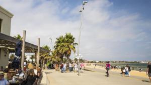a group of people walking on a sidewalk near the beach at Garden Cottage St Kilda in Melbourne +10 photos