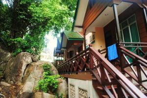 a house with a wooden staircase outside of it at Tuna Bay Island Resort in Perhentian Islands
