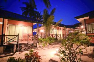 a row of houses at night with lights at Tuna Bay Island Resort in Perhentian Islands