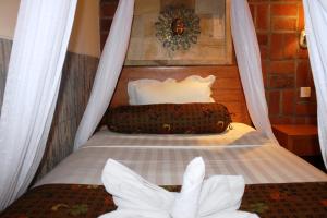 Postel nebo postele na pokoji v ubytování Mans Cottages & Spa