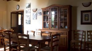 a dining room with a wooden table and chairs at Agriturismo Poggio alle Calle in Saturnia