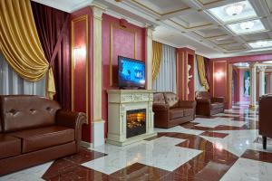 a living room with a fireplace and a television at Gostinitsa Krasnaya in Blagoveshchensk