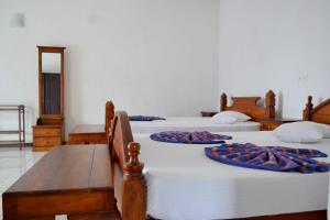 Ένα ή περισσότερα κρεβάτια σε δωμάτιο στο Hotel Breeta's Garden