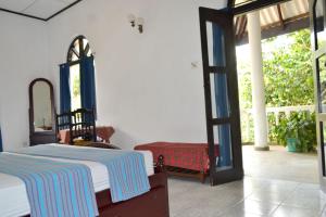 Ένα ή περισσότερα κρεβάτια σε δωμάτιο στο Hotel Breeta's Garden