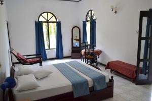 Ένα ή περισσότερα κρεβάτια σε δωμάτιο στο Hotel Breeta's Garden