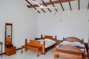 Ένα ή περισσότερα κρεβάτια σε δωμάτιο στο Hotel Breeta's Garden