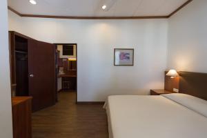 a hotel room with a bed and a hallway at Tuna Bay Island Resort in Perhentian Islands