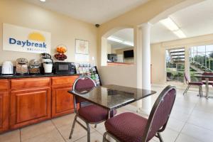 a kitchen with a table and chairs in a room at Days Inn by Wyndham Turlock in Turlock