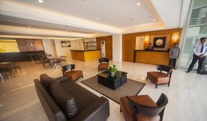 eine Lobby mit einem Sofa und Stühlen sowie einer Bar in der Unterkunft NS Royal Hotel in Cebu City