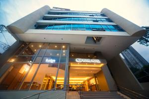 a large building with a sign on the side of it at NS Royal Hotel in Cebu City