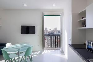 a kitchen with a table and chairs and a balcony at Relais Castel Nuovo in Naples