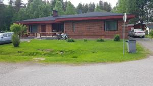 a house with a motorcycle parked in front of it at Arctic Red House in Rovaniemi