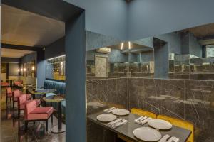 
a kitchen with two sinks and a table with plates of food on it at Otivm Hotel in Rome
