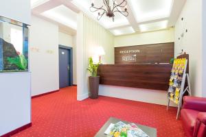 a waiting room with a reception desk and a red carpet at Five Points Square - City Center in Belgrade