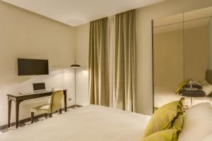 Tempat tidur dalam kamar di Otivm Hotel