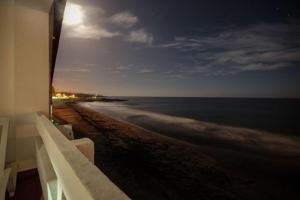 a view of the ocean from a balcony of a building at Aparthotel Barracuda in Ponta Delgada