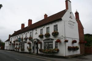 a white building with flower boxes on the windows at The Angel Inn (Blyth) in Blyth
