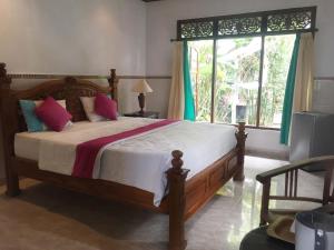 a bedroom with a large bed and a window at Bagus Homestay in Ubud