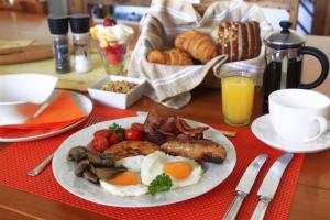 a plate of breakfast food on a table at The Muize in Muizenberg