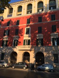a red building with cars parked in front of it at Augustana House and Suites in Rome