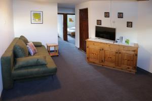 a living room with a couch and a flat screen tv at Haus Kathrein in Prutz