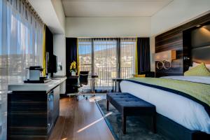 a hotel room with a bed and a desk and a window at Hotel Beaulac in Neuchâtel +53 photos