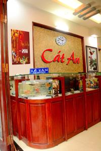 a restaurant with a cataan sign on a counter at Cat An Guesthouse in Hue