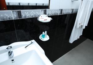 a bathroom with a sink and a toothbrush holder at Celestial Inn in Mirissa +108 photos