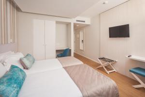 Postel nebo postele na pokoji v ubytování Essence Inn Marianos Hotel