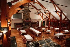 a large room with tables and chairs and a fireplace at Tinaroo Lake Resort in Tinaroo