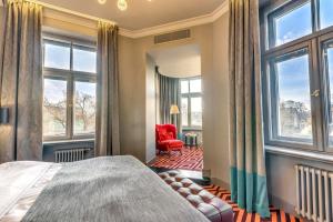 a bedroom with a bed and a window at Grand Poet Hotel and SPA by Semarah in Riga