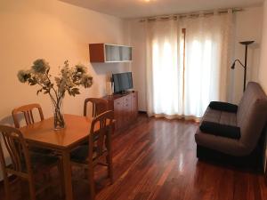 a living room with a table and a couch at Altur 5 Canfranc Estación in Canfranc-Estación