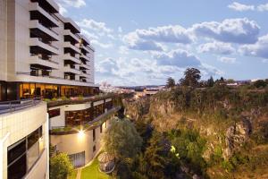 an apartment building with a view of a mountain at Hotel Miracorgo in Vila Real