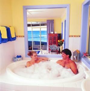 two people in a bath tub in a bathroom at Al Mare Beachfront Retreat Award Winner in The Entrance