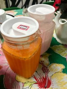 a jar of sauce sitting on a table with a table cloth at Pousada Tia Cleide in Caraguatatuba
